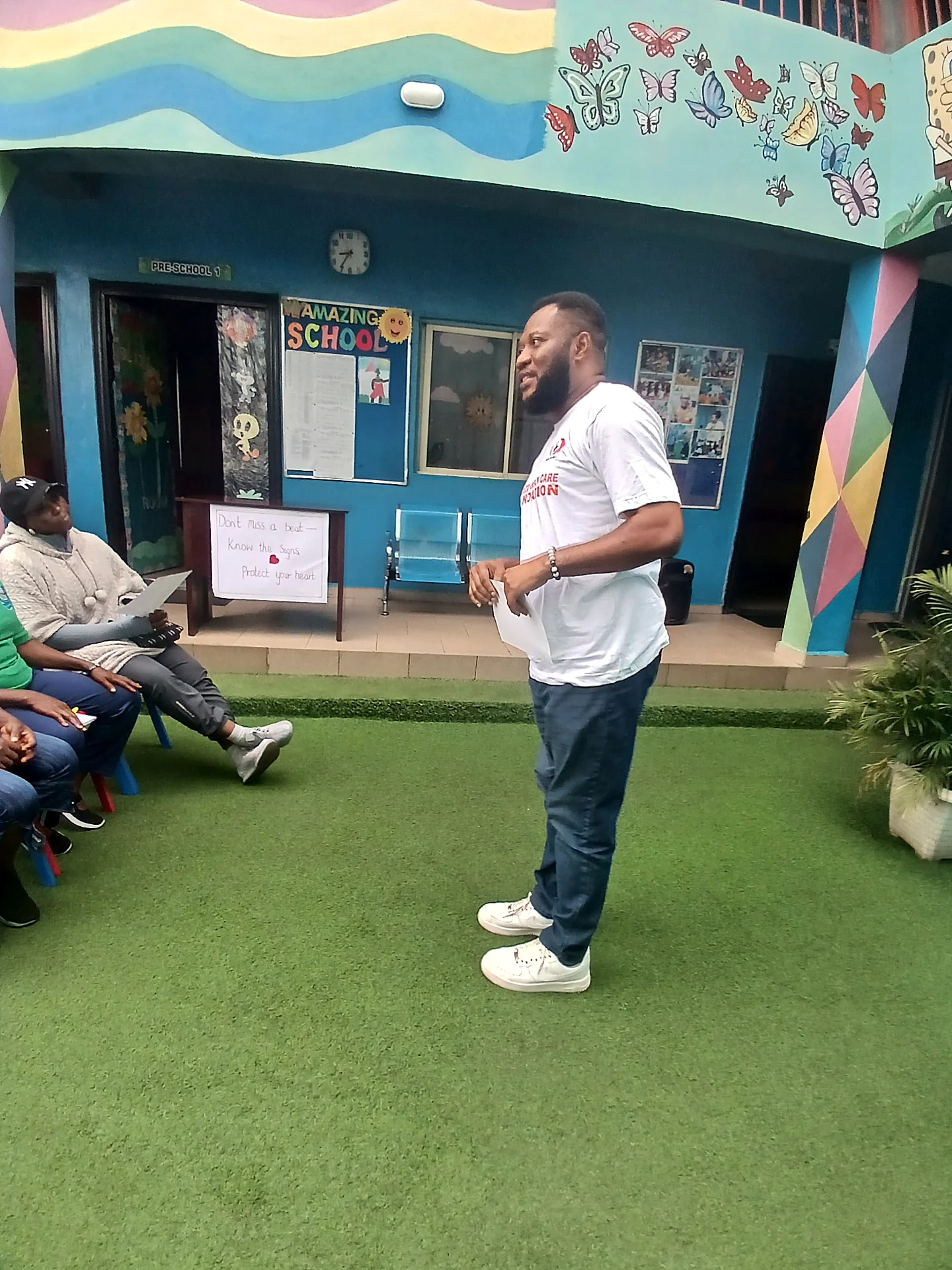 Foundation representative speaking in the school courtyard