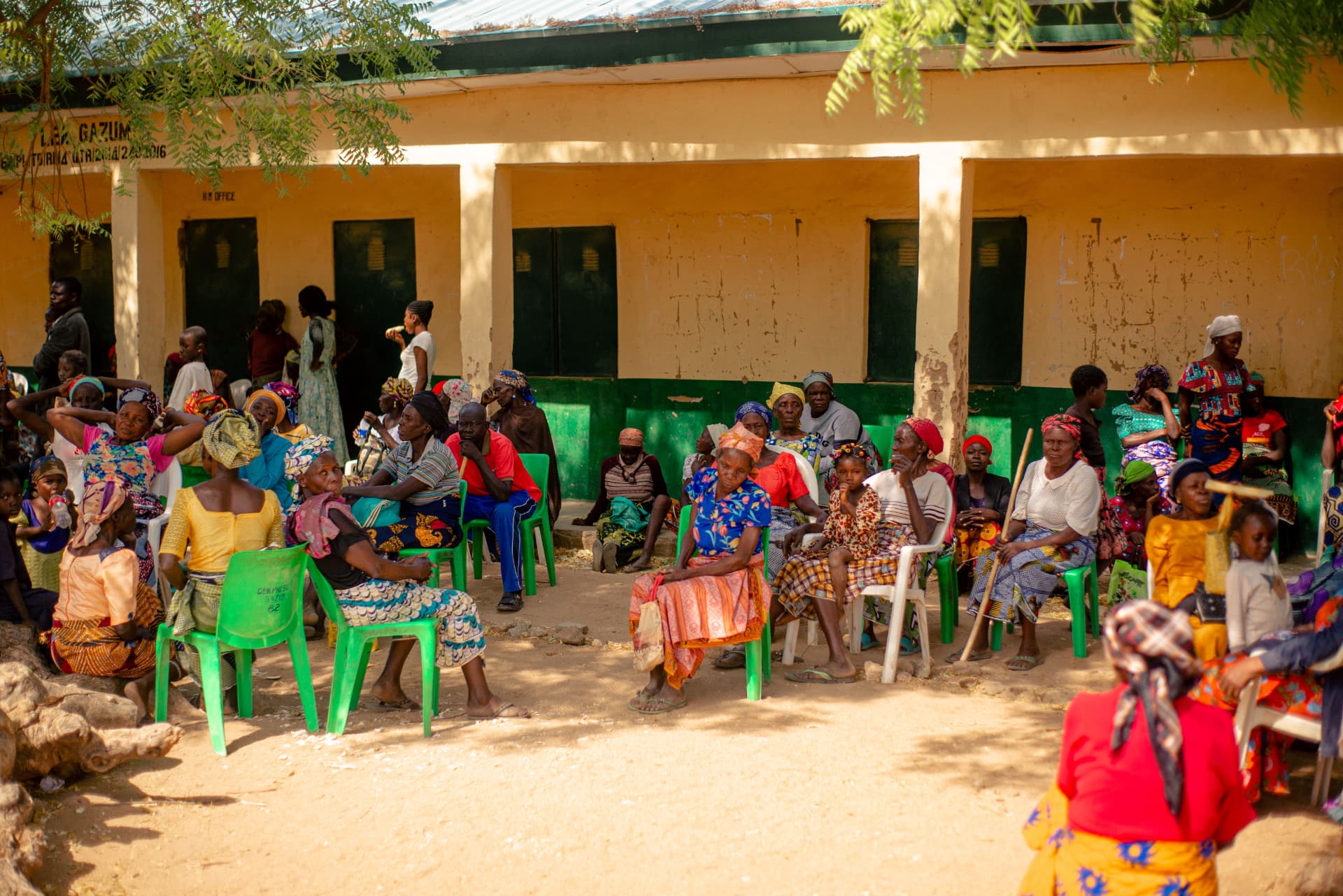 Community members waiting for eye screening outside a rural school