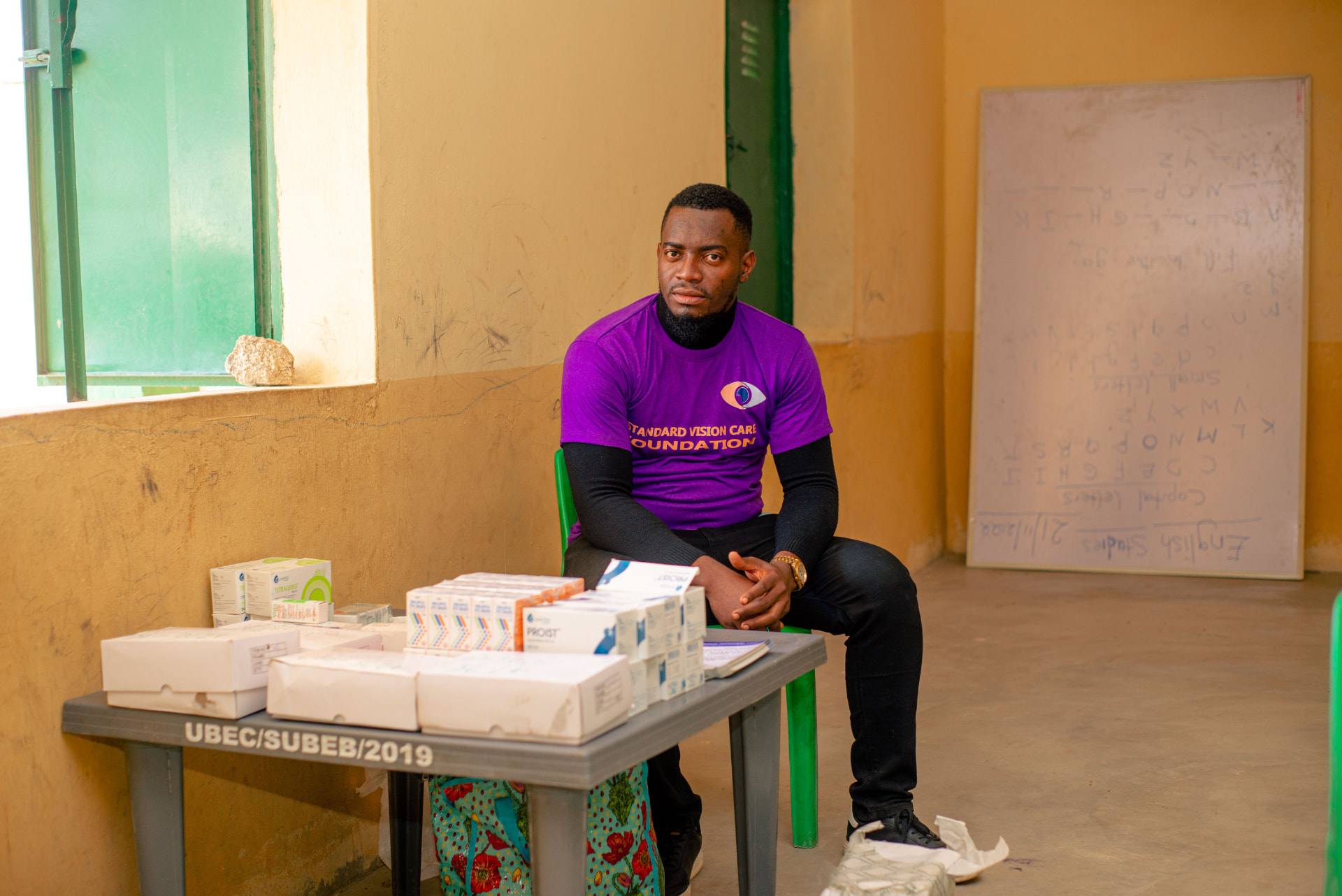 Foundation volunteer with eye medications prepared for distribution at an outreach